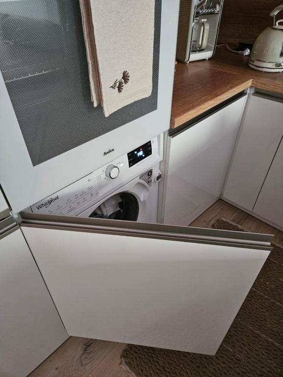 a washer and dryer in a dishwasher in a kitchen at Baltic Nature in Łukęcin