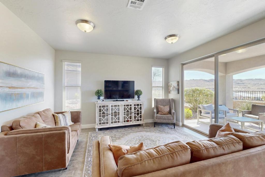 a living room with a couch and a tv and a table at The Desert Star Villa in Washington