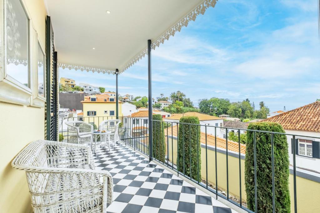 a balcony with a black and white checkered floor at Villa Til Gallery in Funchal