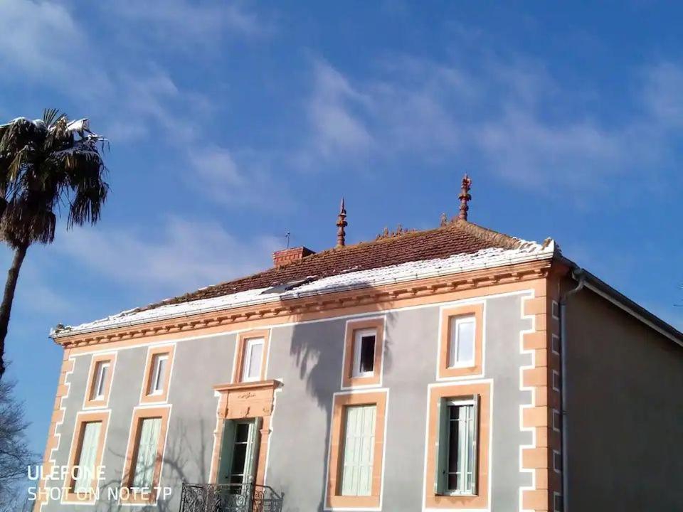 a white building with two crosses on top of it at Pause à la campagne au grand air des Pyrénées in Saint-Marcet
