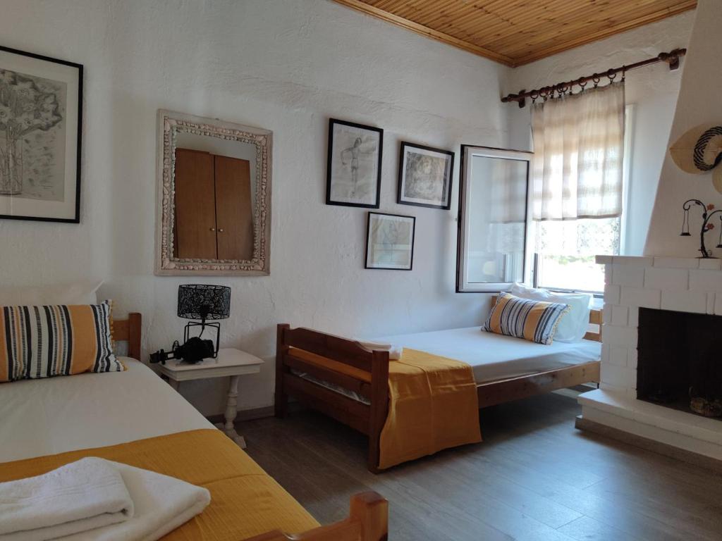 a bedroom with a bed and a fireplace and a window at Summer place Pefkohori in Pefkohori