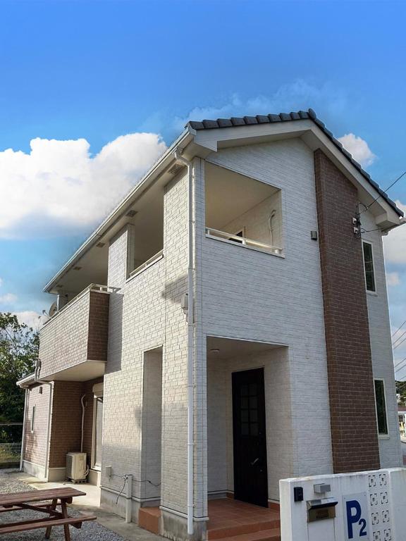 a white brick building with a window on it at 水族館に近いゆったり別荘-Ent Terrace Okinawa in Motobu