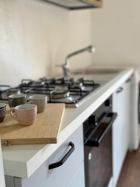 a kitchen with a stove with cups on a cutting board at Bartolo Health and Wellness in Cagliari