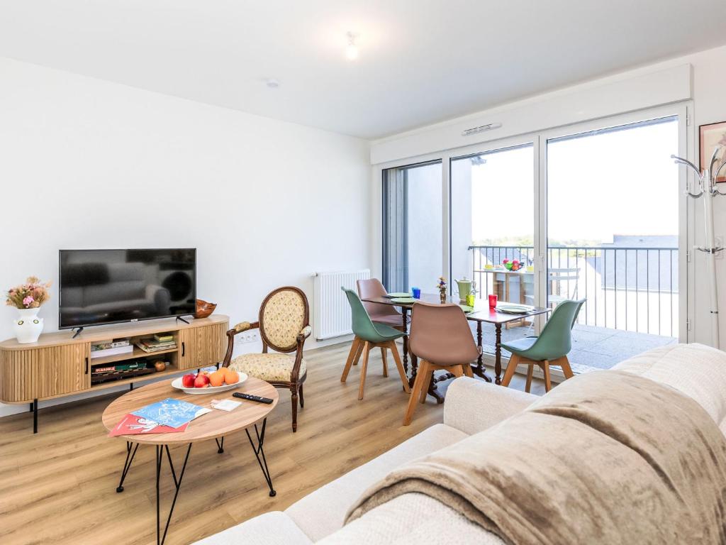 a living room with a couch and a table at Apartment Colette by Interhome in Saint-Coulomb