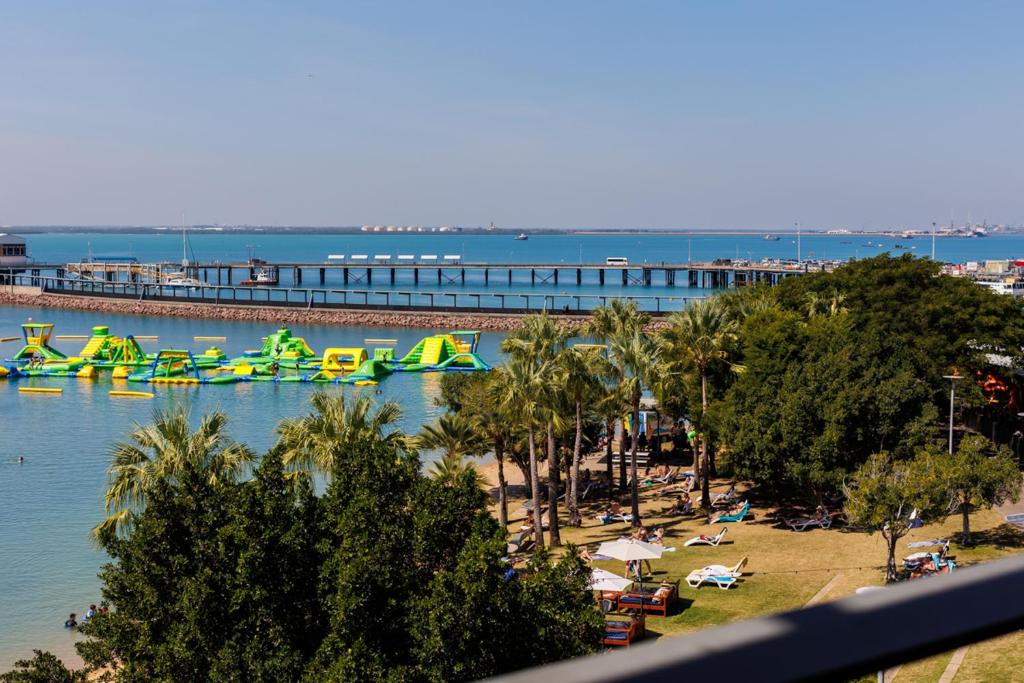 a view of a water park with a roller coaster at Delightful Waterfront Lagoon Views & Restaurants in Darwin