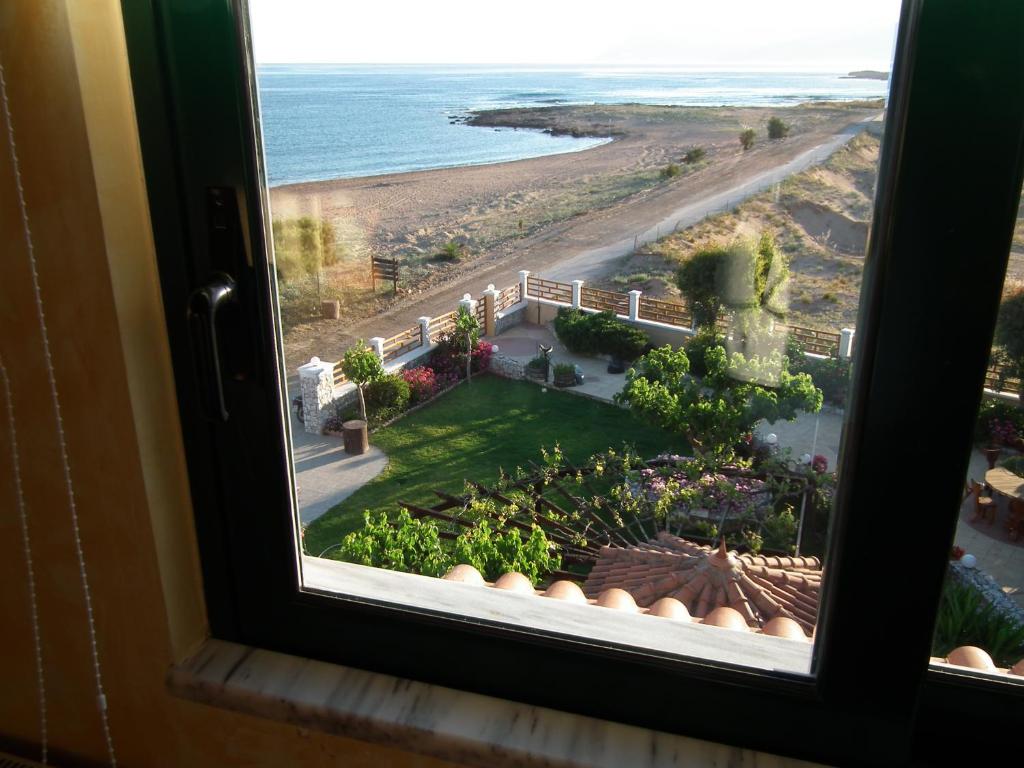 a window with a view of a beach and the ocean at Gramvoussa Bay in Kissamos