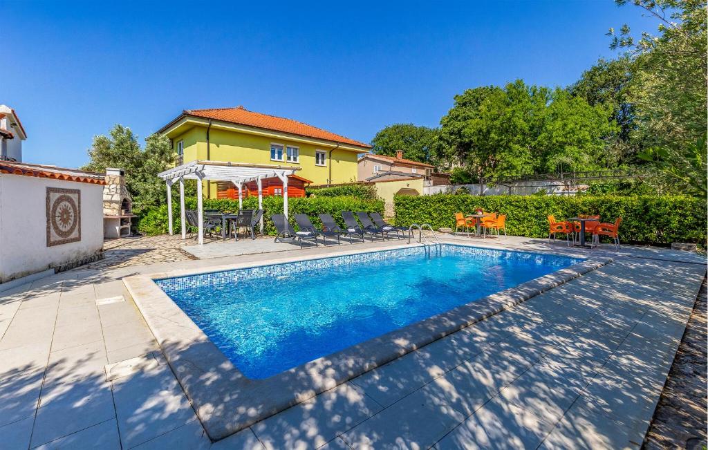 a swimming pool in front of a house at Stunning Apartment In Medulin With Wifi in Medulin