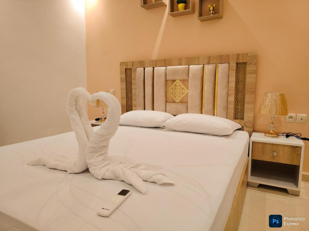 Ένα ή περισσότερα κρεβάτια σε δωμάτιο στο Appartement de 3 chambres avec piscine et climatiseur sur la Plage de Achakar