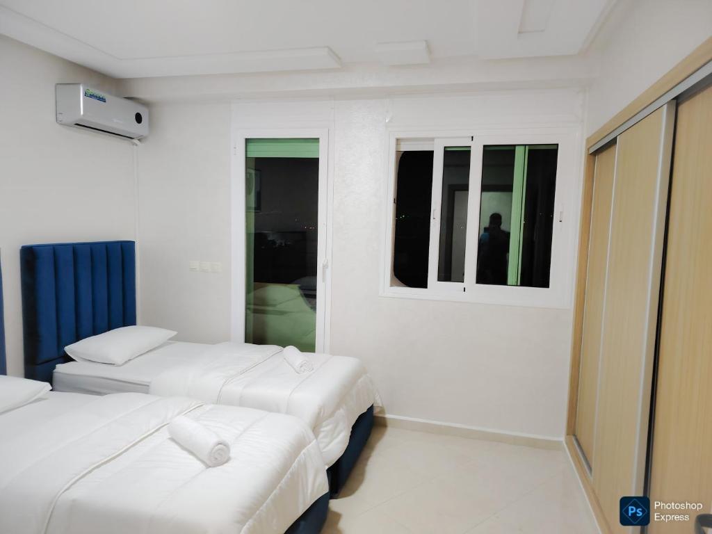 Ένα ή περισσότερα κρεβάτια σε δωμάτιο στο Appartement de 3 chambres avec piscine et climatiseur sur la Plage de Achakar