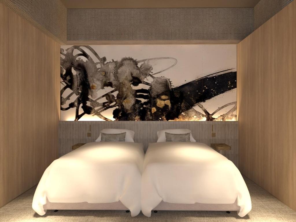Postel nebo postele na pokoji v ubytování KAMENOI HOTEL Arima