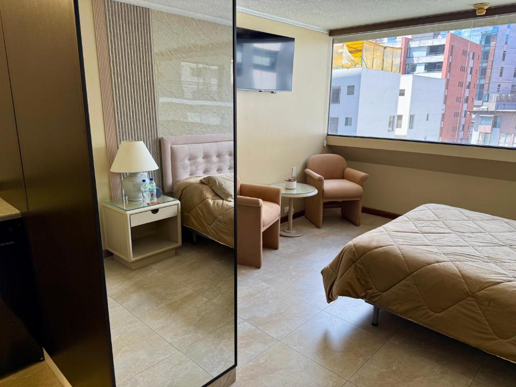 Postel nebo postele na pokoji v ubytování Akros Suite Quito