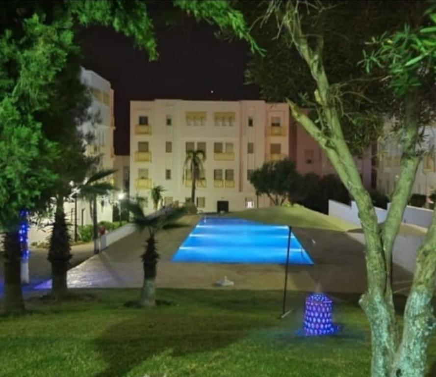 a large swimming pool in a park at night at RELAX Nouvelle ville ibn batouta Tanger in Tangier