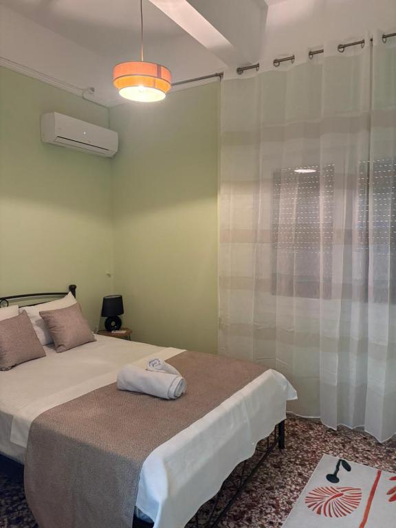 a bedroom with a bed and a glass shower at SMYRNA HOMES CHiOS ERATO in Chios