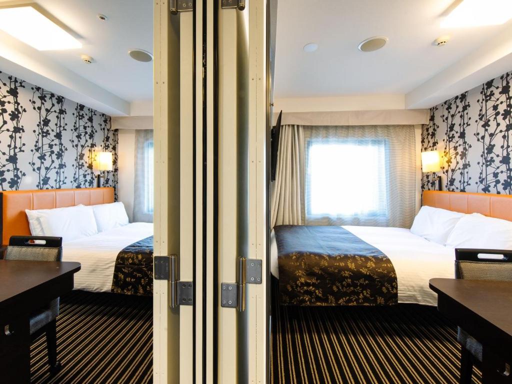 Postel nebo postele na pokoji v ubytování APA Hotel Namba Shinsaibashi