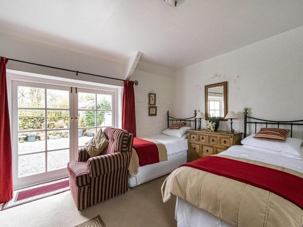 a bedroom with two beds and a window at Secluded Holiday Home in Ceredigion with Garden in Pennant