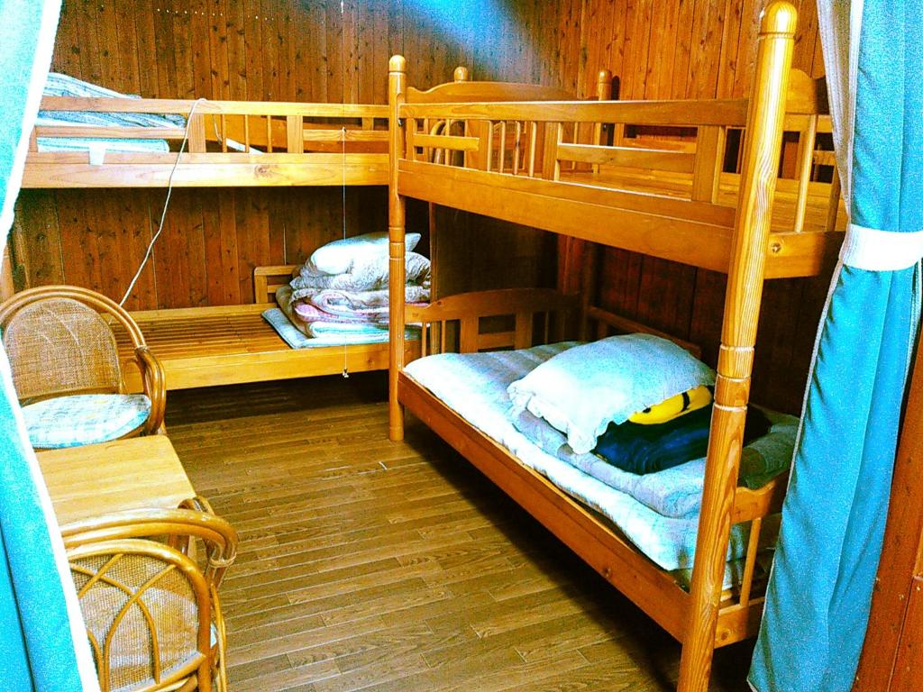 a room with two bunk beds in a cabin at Guest House Miyakojima in Miyako-jima