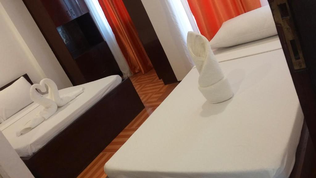 Postel nebo postele na pokoji v ubytování Ricardo Valley Inn