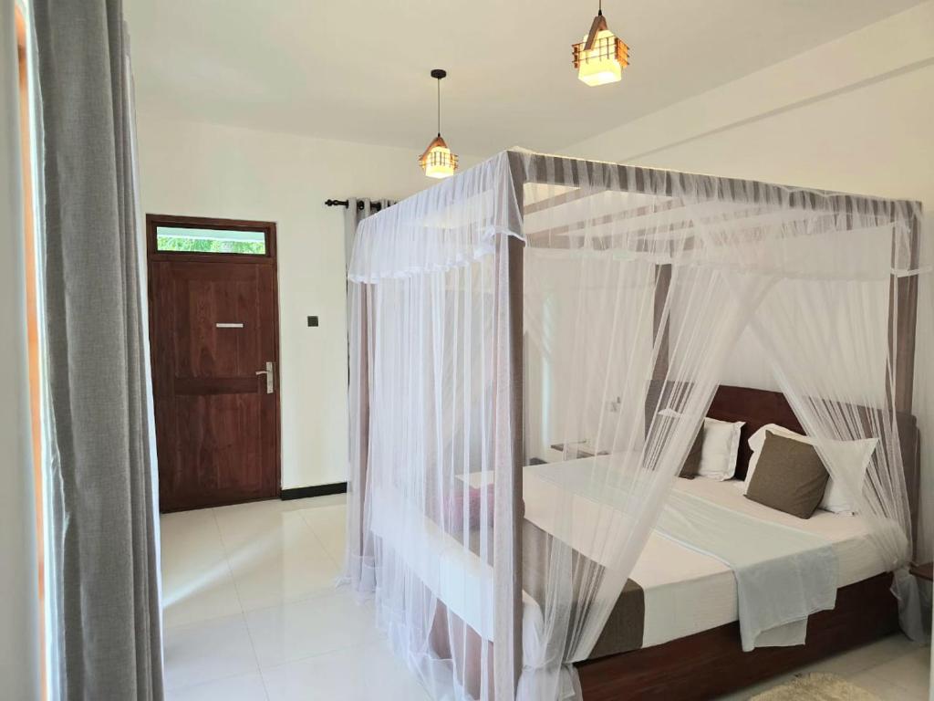 Postel nebo postele na pokoji v ubytování Sigiriya Paradise Inn