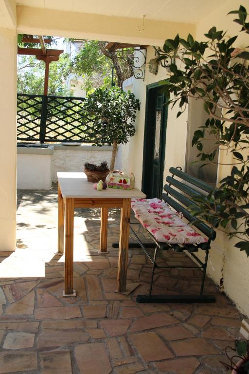 a wooden table and a bench sitting on a patio at Chios Stone House in Chios