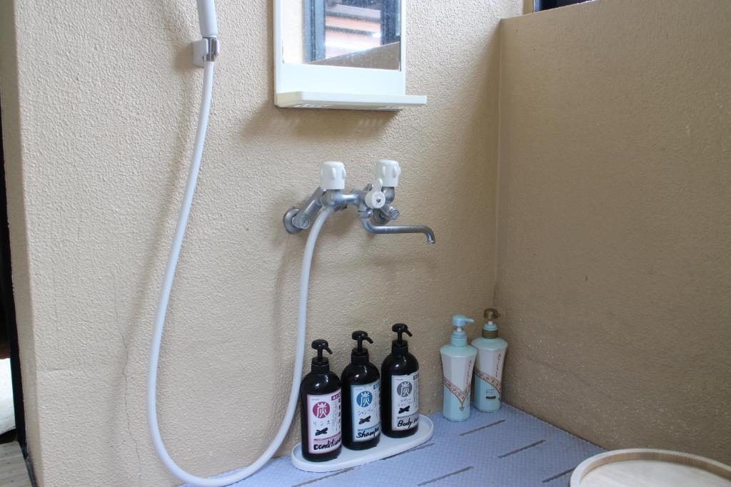 - une salle de bains pourvue d'une douche avec des bouteilles à l'étage dans l'établissement Yufuin-Sanso Waremokou, à Yufu 125 autres photos
