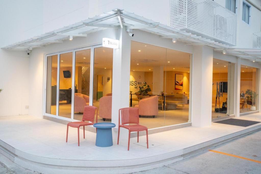 a building with two chairs and a table in it at 777Bliss Hometel in Nakhon Phanom