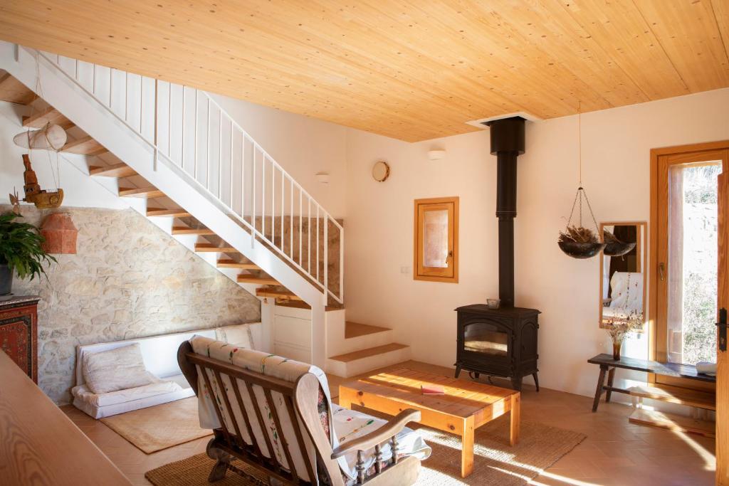 a living room with a staircase and a fireplace at Casa artística i acollidora a Pau in Pau