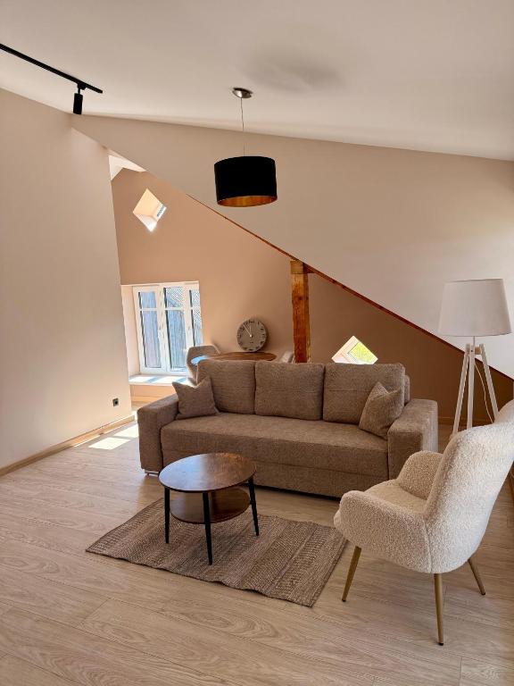 a living room with a couch and a table at Atpūta Grašos Mazirbe in Mazirbe