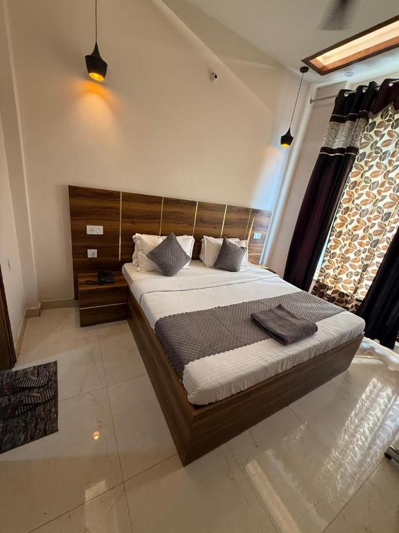 Postel nebo postele na pokoji v ubytování Hotel kartik