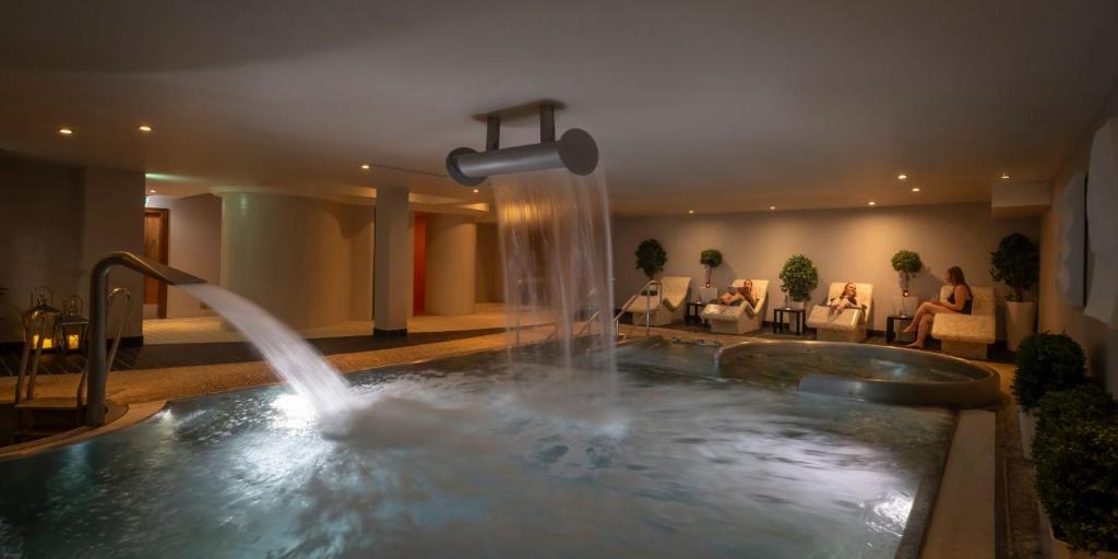 a pool with a fountain in a hotel room at Whites of Wexford in Wexford
