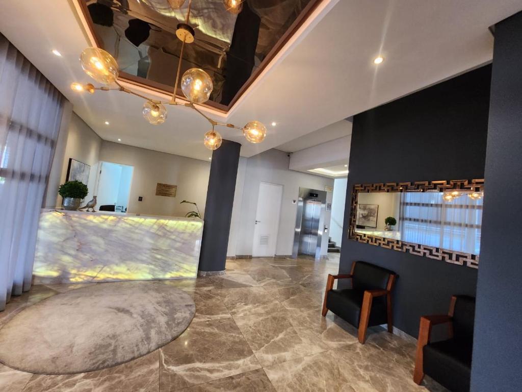 a large room with a lobby with a table and chairs at Zayna in Johannesburg