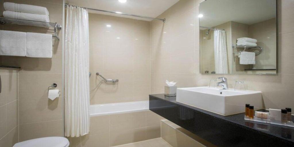 a bathroom with a sink and a toilet and a tub at Whites of Wexford in Wexford