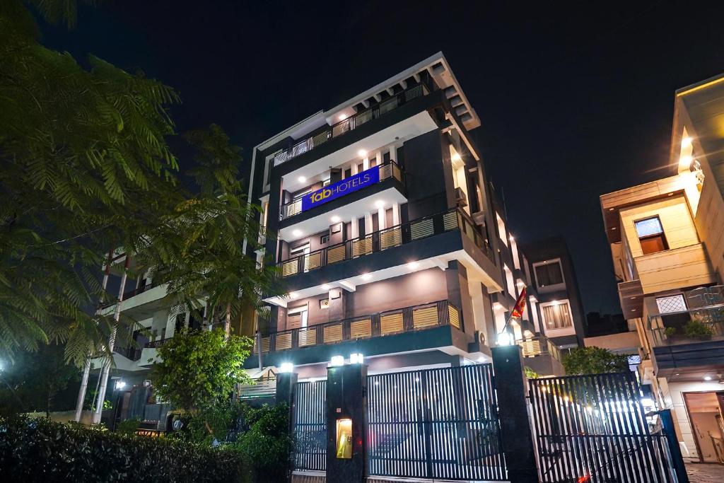 a building with a sign on it at night at FabHotel Novis Stayz in Noida