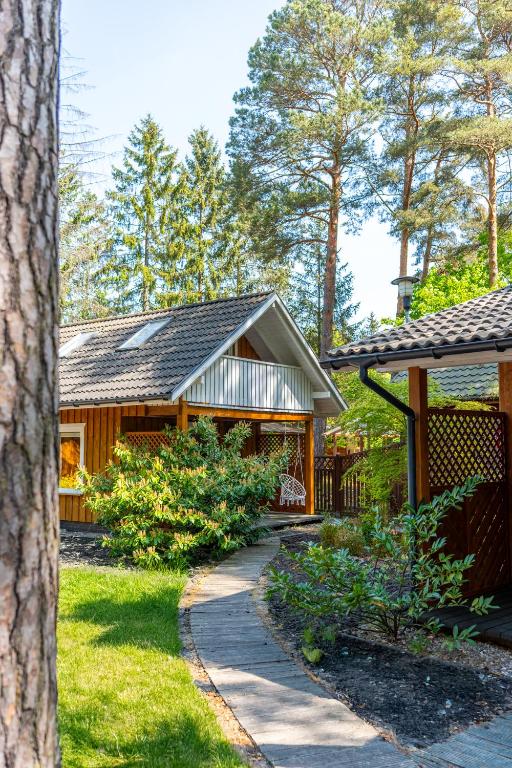 a house with a walkway in front of it at Domki Pogorzelica in Pogorzelica