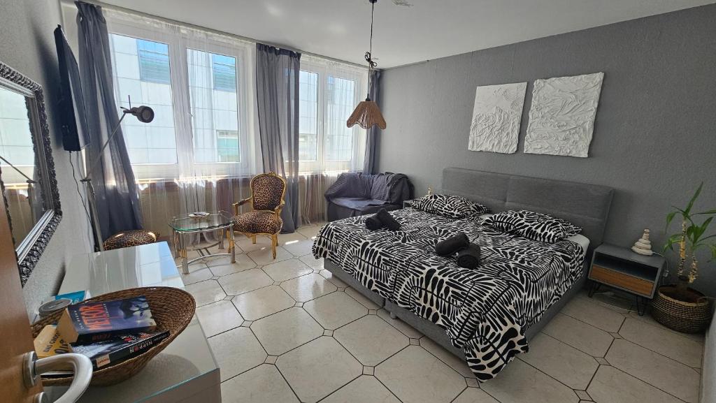 a bedroom with a bed and a table and chairs at Central Charm - Bedroom & Kitchen Apartment near the Main Station Hauptbahnhof in Wuppertal