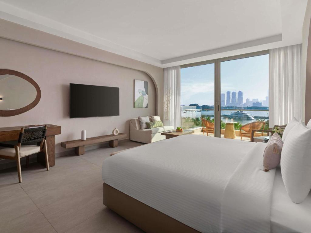 Ein Bett oder Betten in einem Zimmer der Unterkunft Rixos The Palm Hotel &amp; Suites - Ultra All Inclusive