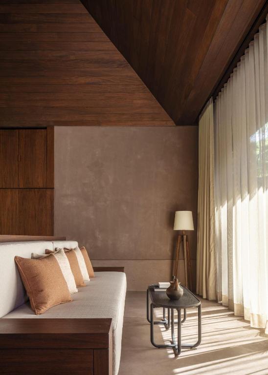 a bedroom with a bed and a table at One&Only Mandarina in Lo de Marcos