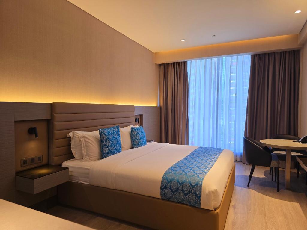 Postel nebo postele na pokoji v ubytování Bayprime Hotel