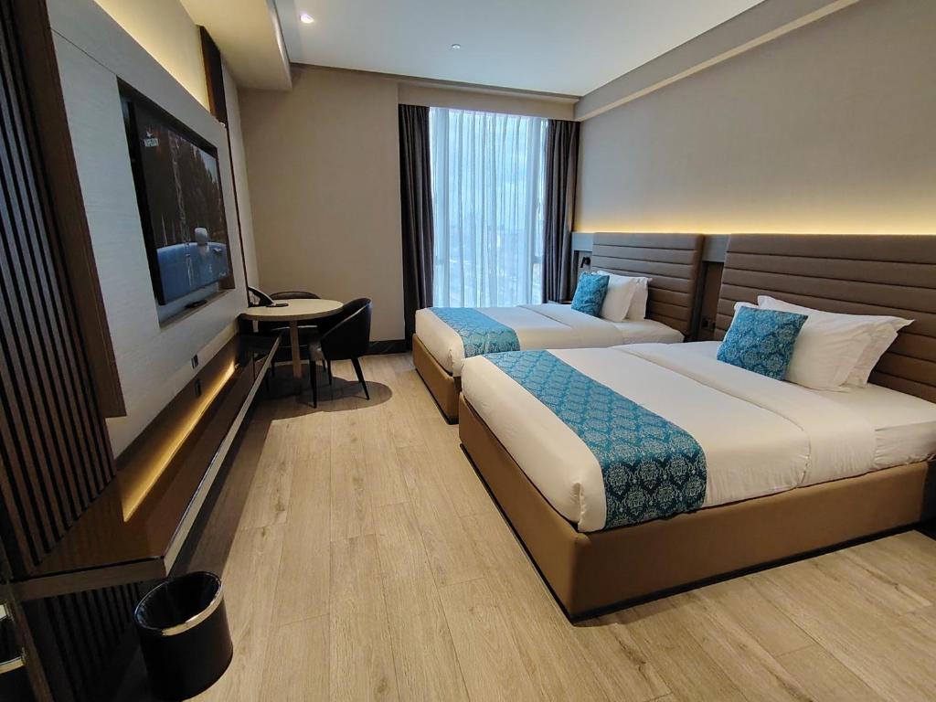 Postel nebo postele na pokoji v ubytování Bayprime Hotel