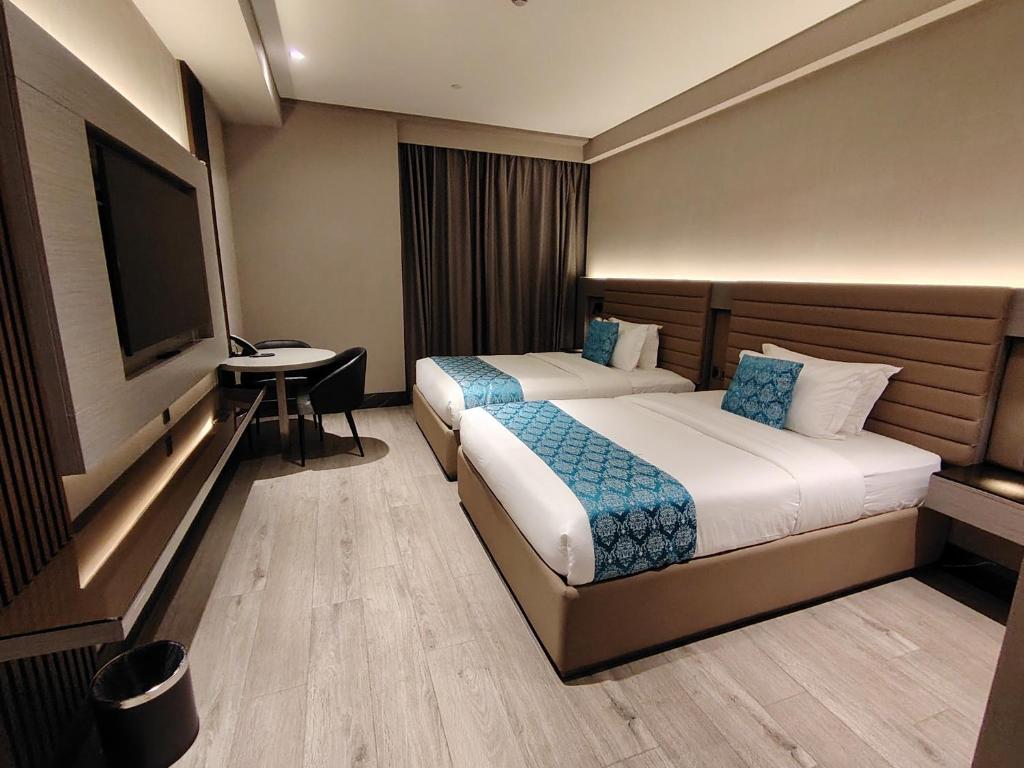 Postel nebo postele na pokoji v ubytování Bayprime Hotel