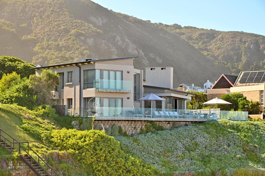 a house on a hill with a mountain in the background at At Last Glentana Beach Manor in Glentana