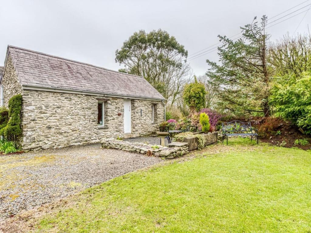 a stone house with a garden in front of it at Secluded Holiday Home in Ceredigion with Garden in Pennant