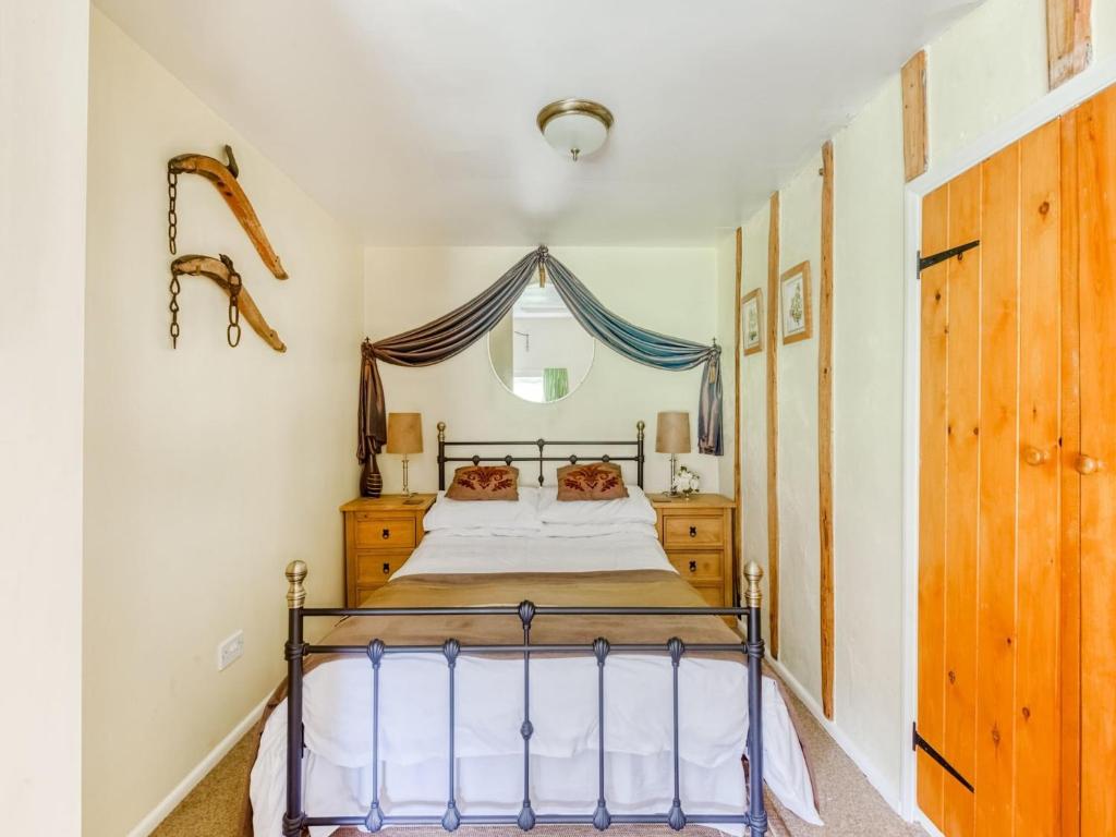 a bedroom with a bed and a window at Secluded Holiday Home in Ceredigion with Garden in Pennant