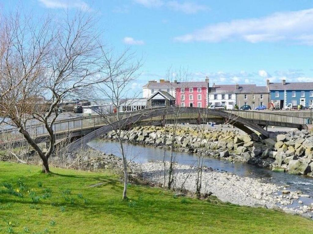 a bridge over a river with a train on it at Secluded Holiday Home in Ceredigion with Garden in Pennant