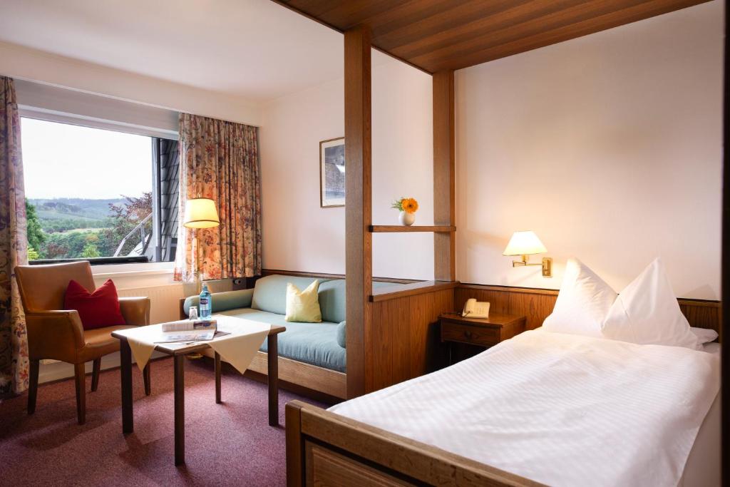 Postel nebo postele na pokoji v ubytování Romantik Hotel Störmann