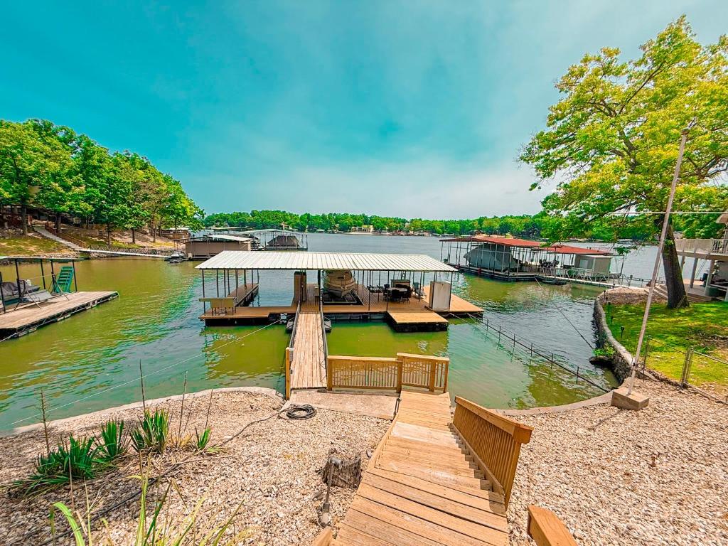 a house on a dock on a river at Landing on Lake Time: Lakefront-4BD/2BA/Private Dock/Decks/Firepit-10PP in Gravois Mills