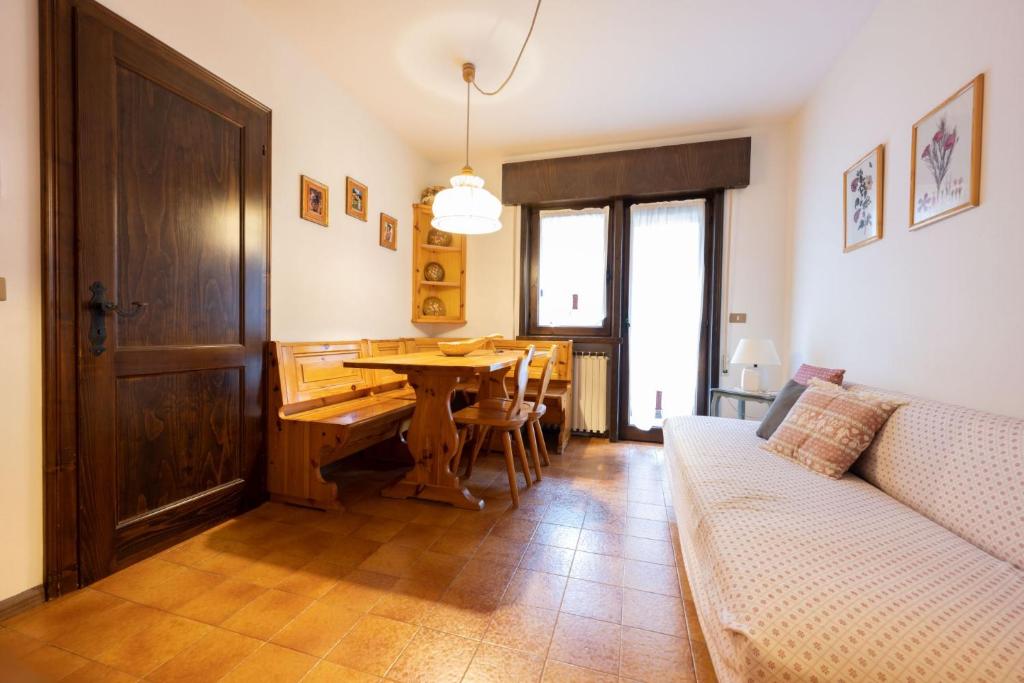 a living room with a table and a couch at Cesa Alpes 3 in Campitello di Fassa