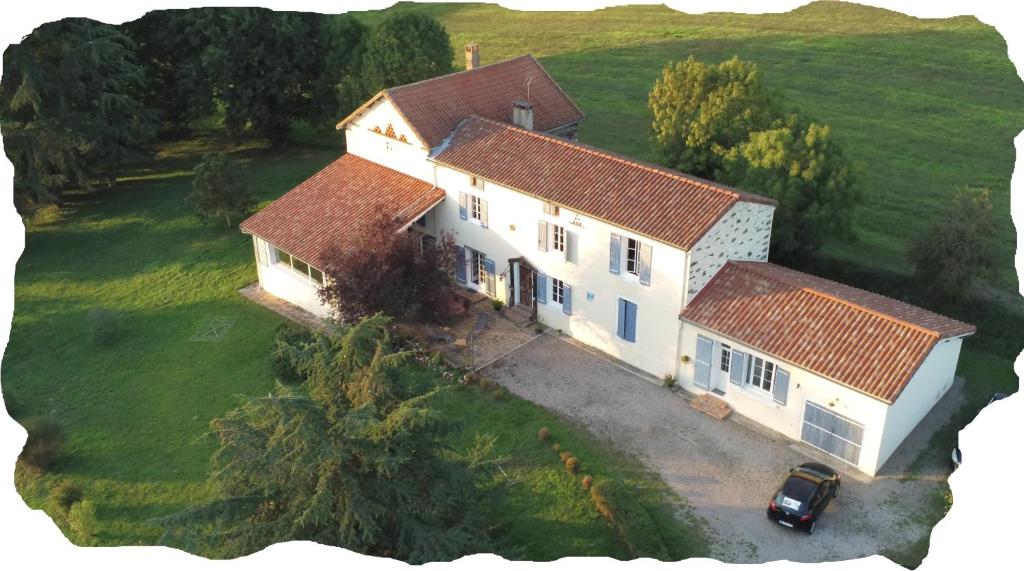 an aerial view of a house with a car in front at La Maison Bleue in Rosières