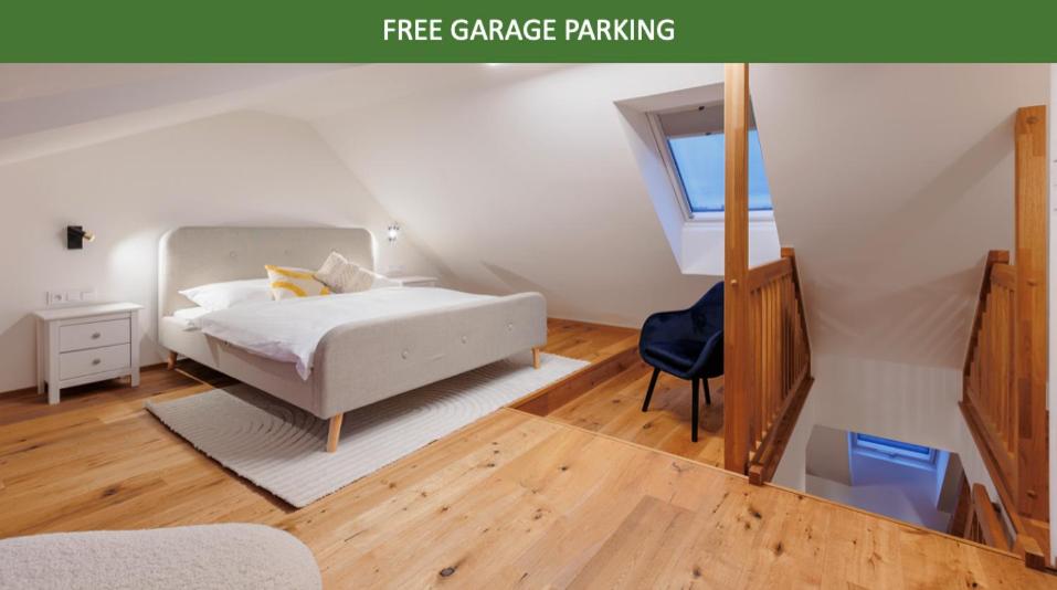 a bedroom with a white bed and a blue chair at 2 rooms apartment with terrace and FREE parking near metro in Prague