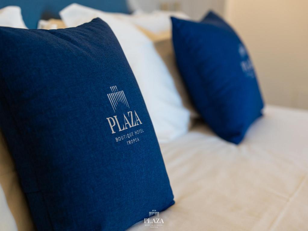 A bed or beds in a room at PLAZA Boutique Hotel - Tropea