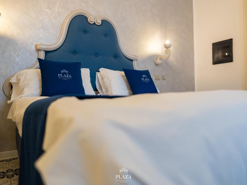 A bed or beds in a room at PLAZA Boutique Hotel - Tropea